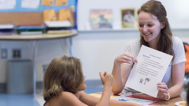 Student teaching one-on-one in elementary school setting.