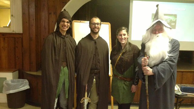 Psychology professor Paul Mazeroff with students presenting on Tolkien's Lord of the Rings