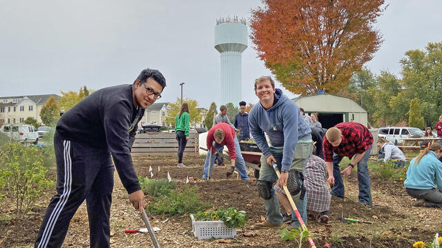 McDaniel College students Jose Osorio and Gunnar Ward till the campus garden.