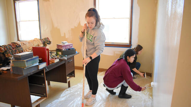 McDaniel freshmen Brooke Boyland, left, Bopha Bessire, center, and Sydney Barrett help paint the multipurpose room at Union Street United Methodist Church on Monday, Jan. 20.