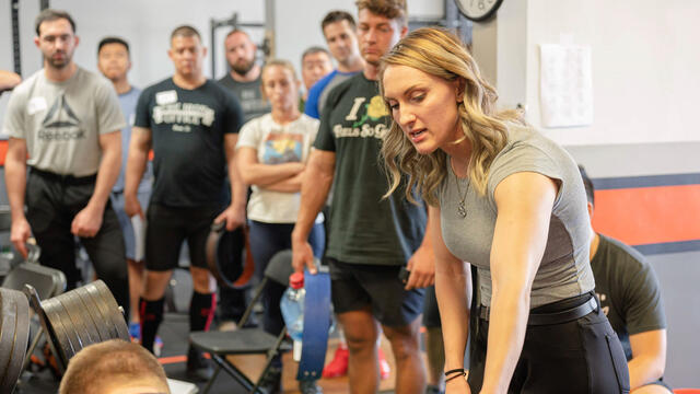 Nicole Rutherford ’16 teaches the deadlift as a platform coach at the L.A. Starting Strength seminar.