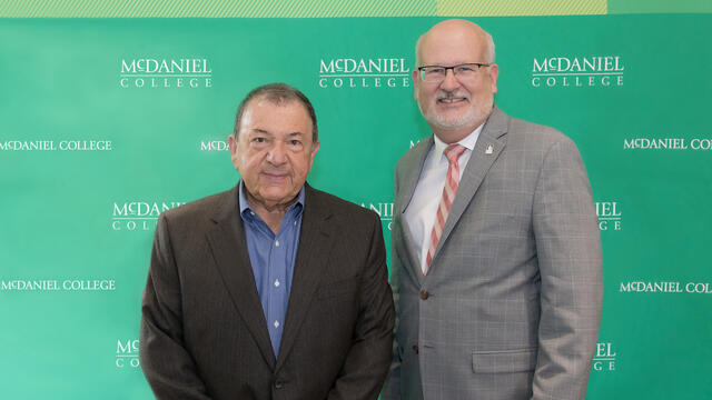 Martin K.P. Hill, current trustee and former board chair, with McDaniel President Roger N. Casey