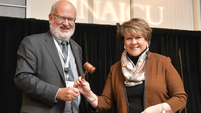 President Roger N. Casey accepts the NAICU Board Chair gavel from outgoing Chair Jo Allen, president of Meredith College (NC).
