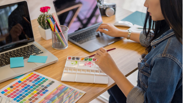 woman at desk painting