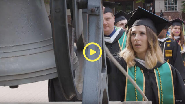 graduating student rings the Old Main Bell