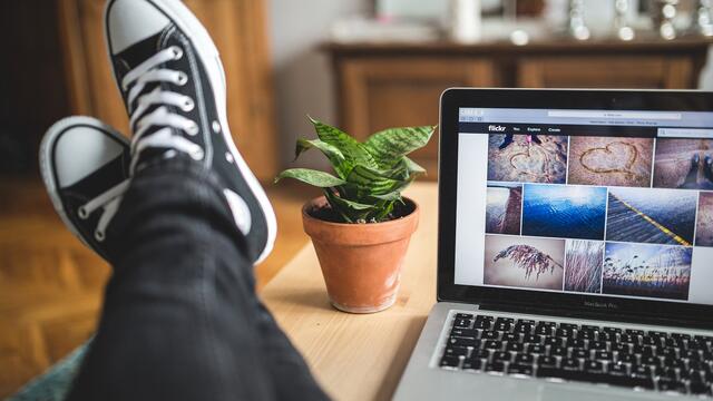 feet propped on table next to laptop