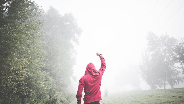 boy walking alone in the fog