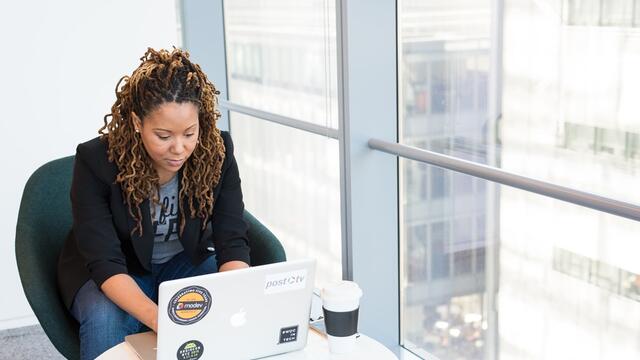 Young adult female using a laptop.