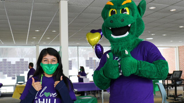 Melissa Torres '24 smiles with the Green Terror on the third annual I Love the Hill Day.
