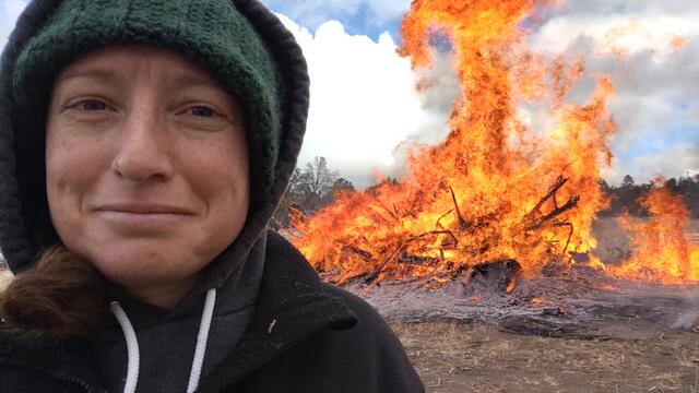 Ellen Larsen '10 in front of a bonfire