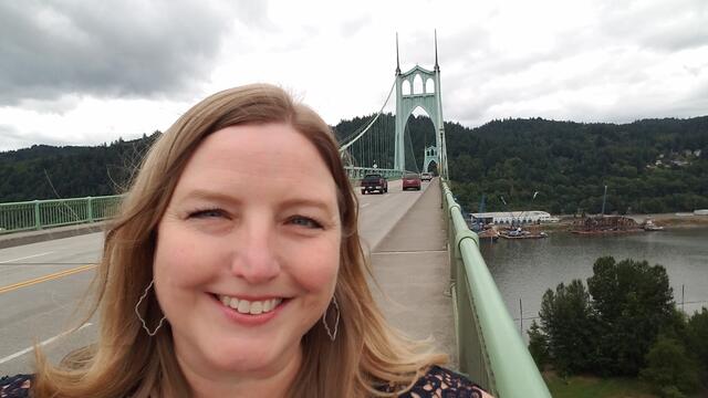 Ginger Bandeen posing in front of a bridge.