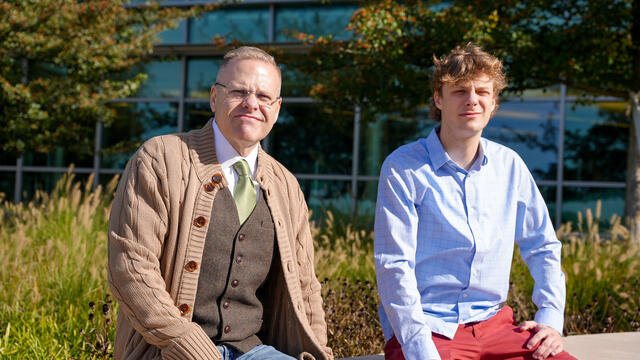 Alum Dominic Byerly sitting with professor Kevin McIntyre.