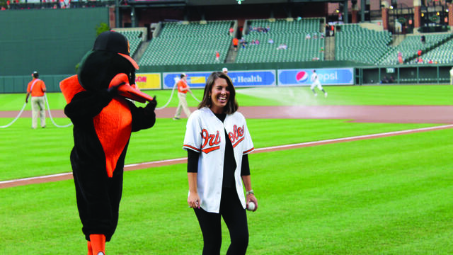 Alumna Lauren Avery '14 throwing the first pitch at an Orioles game.