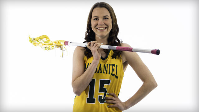 Kaylen Buschhorn poses with a lacrosse stick.