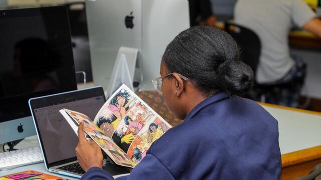 Student Varia Alston reads a comic in the First Year Seminar course titled I am Groot.