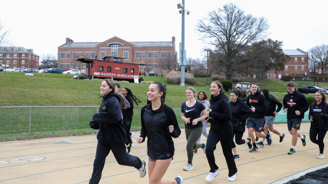 Students in Find Your Strong: Running for Your Life jog on a track.