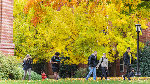 students walk on campus in the Fall