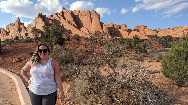 Jenny Sandler, a white woman, stands in Arches National Park.