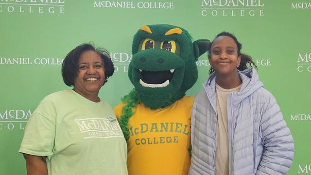 Michele Curry-Creighton poses with her daughter Jordan with the Green Terror mascot.