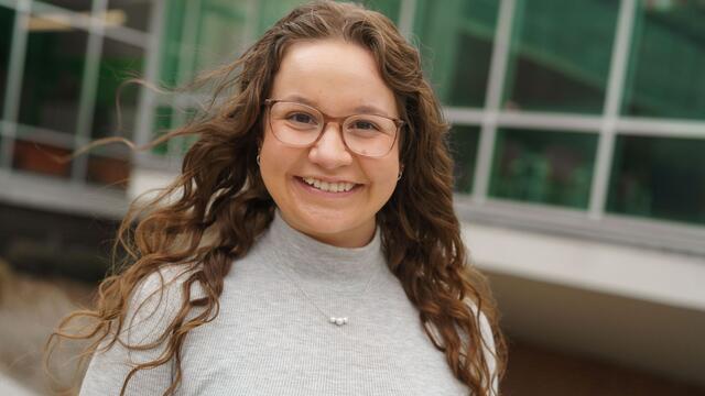 Headshot of Mackenzie McCarter outside the student center wearing a grey shirt.