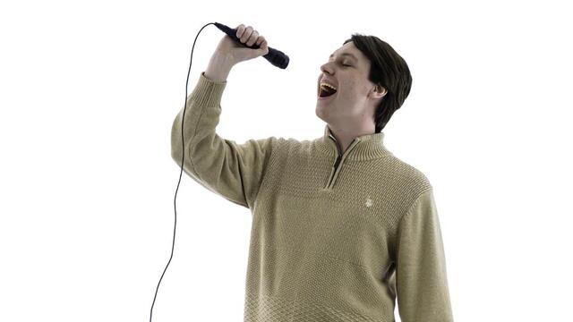 Paul Steinert sings into microphone