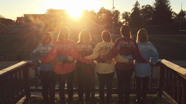 Members of Phi Sigma Sigma with their arms around each other 