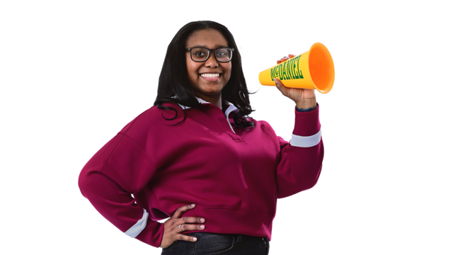 A female student smiles and holds a McDaniel megaphone.