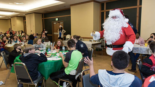 Santa pays a visit to Boys & Girls Club members at the holiday party hosted by McDaniel College
