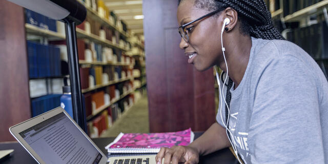 Student on computer in Hoover Library.