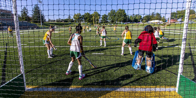 Field Hockey players in action on the field.