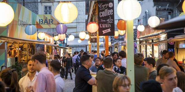 Street decorated with lantern lights showcasing Budapest nightlife.