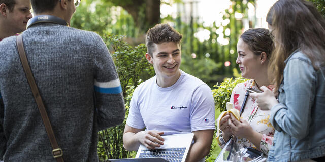 Students sitting outside of Budapest campus.