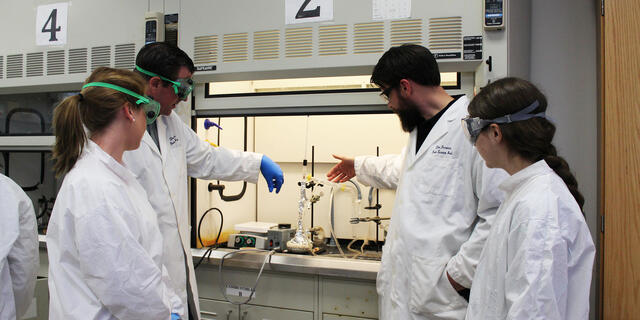 Professor and students in the chemistry lab.