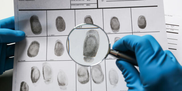 Fingerprints with magnifying glass, closeup