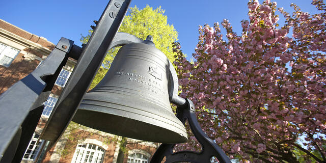 Bell in front of campus in spring