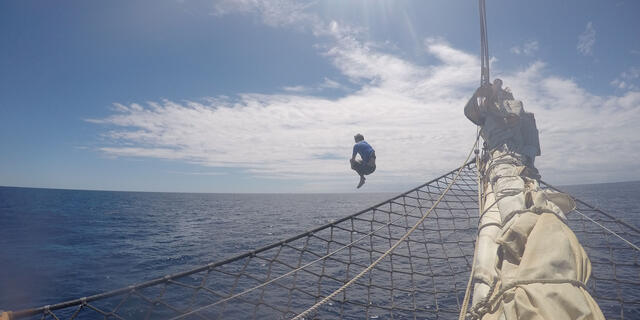 SEA Semester, Ian Kasaitis jumping off boat into the water.