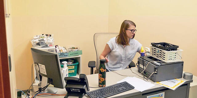 Student sitting behind desk.