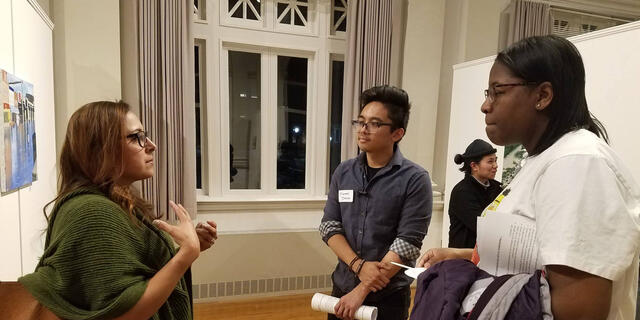 Students talk to an alum at a networking event.