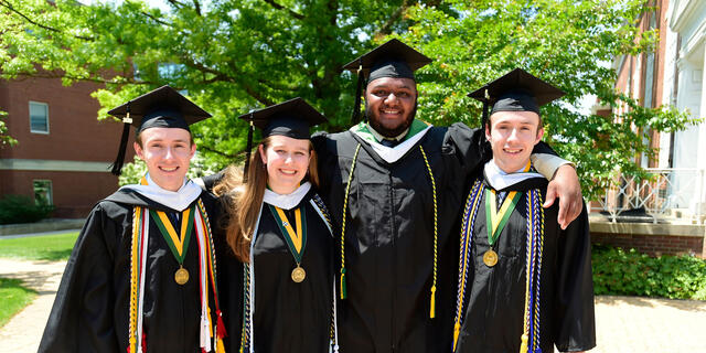 Graduates in cap and gown at Commencement.