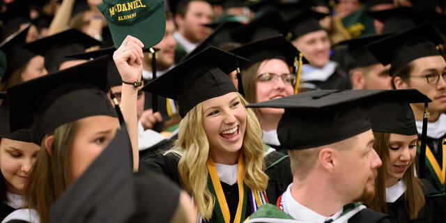 Graduates in cap and gown seated for Commencement.