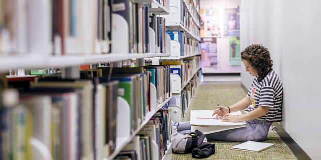 Student drawing in library