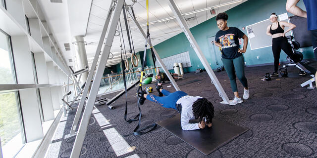 Student exercising in a gym.