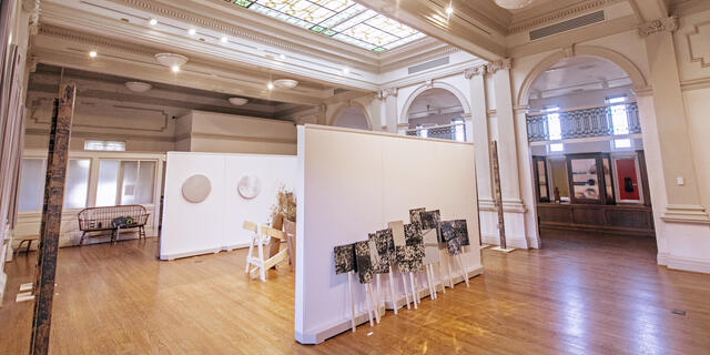 Image of artwork in Rice Gallery beneath a stained glass skylight.