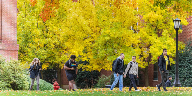 students walk on campus in the Fall