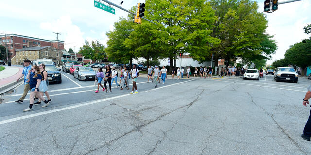 students walk through intersection in downtown westminster