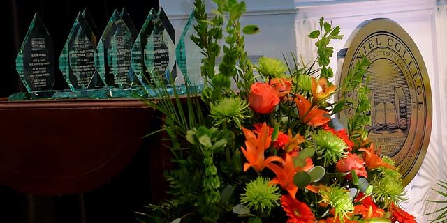 Podium with Alumni Awards on table