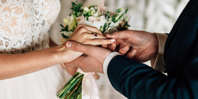 bride and groom exchange wedding rings