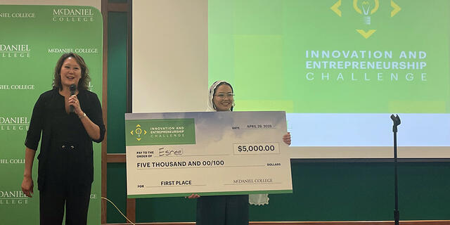 winner poses with $5000 check