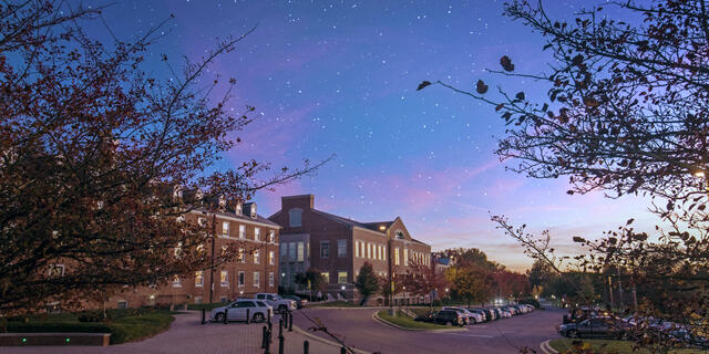 The night sky is filled with stars above Merritt Hall on the McDaniel campus.