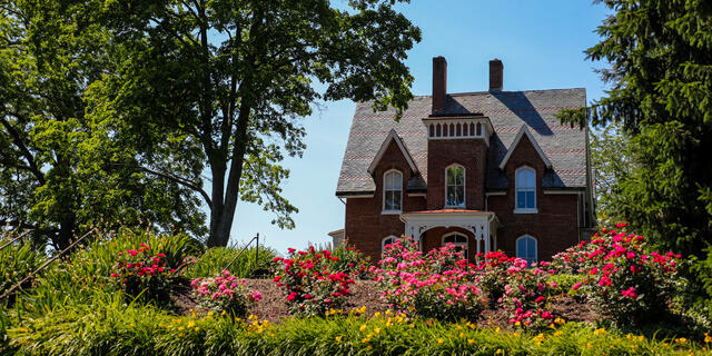 carroll hall in spring/summer with flowers and trees